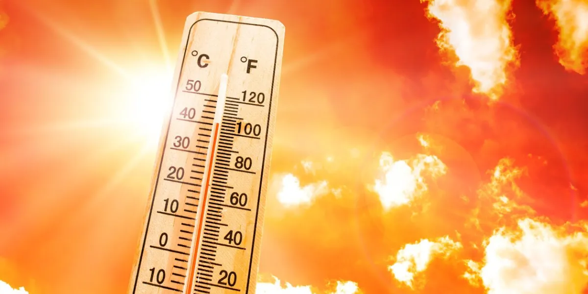 orange sky with bright sun and thermometer symbolizing climate change and global warming