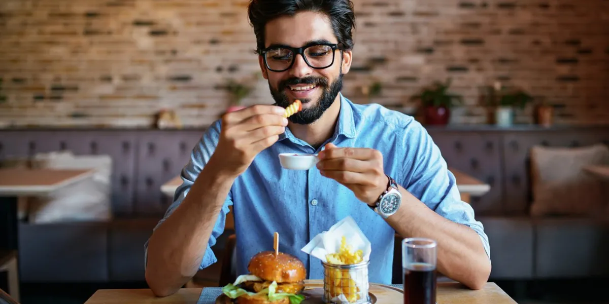 this is so delicious young man sitting in a cafe and enjoying in breakfast food, lifestyle concept
