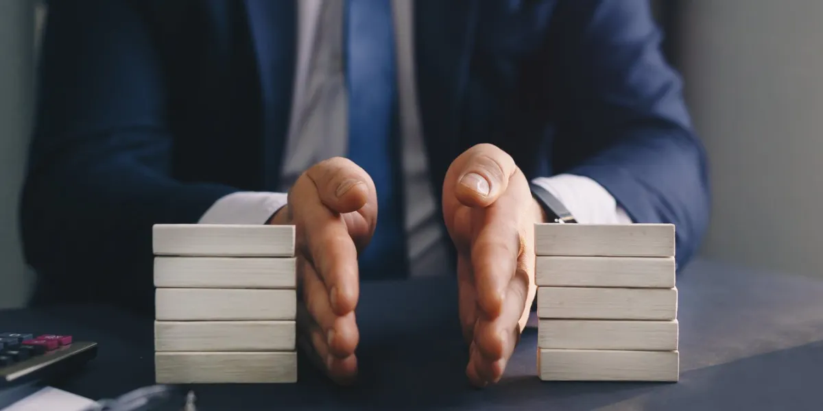 businessman separates wooden block concept of wealth equality division of property divorce and legal services