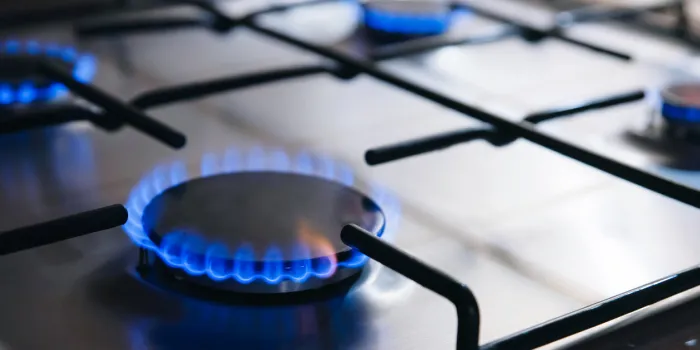 gas kitchen stove cook with blue flames burning panel from steel with a gas