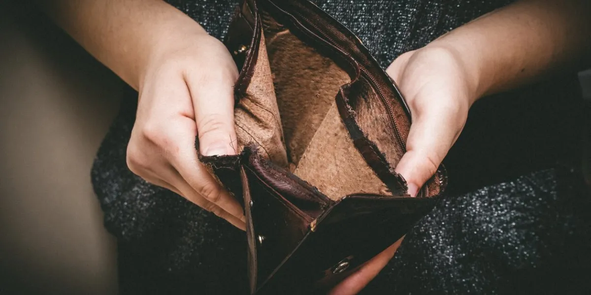old empty wallet in the hands vintage empty purse in hands of women poverty concept, retirement special toning