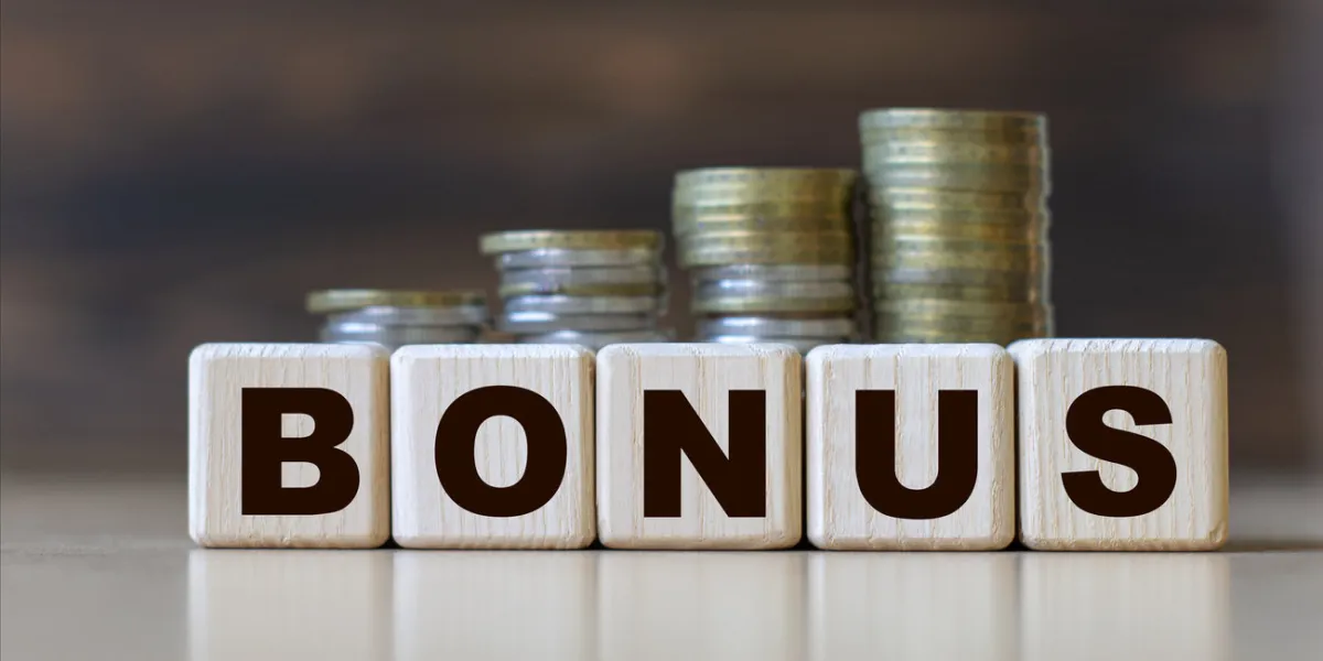 bonus word on diced on a beautiful dark background with coins business concept