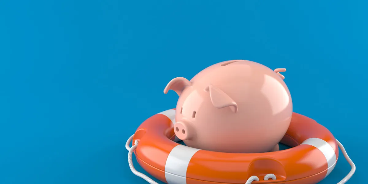 piggy bank with life buoy isolated on blue background