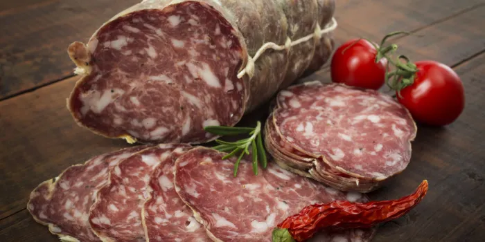 italian salami with red pepper cherry tomatoes on a wooden background
