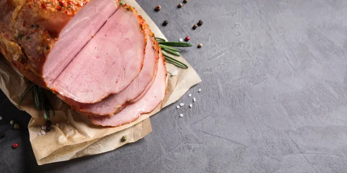 delicious ham on grey table, top view with space for text christmas dinner