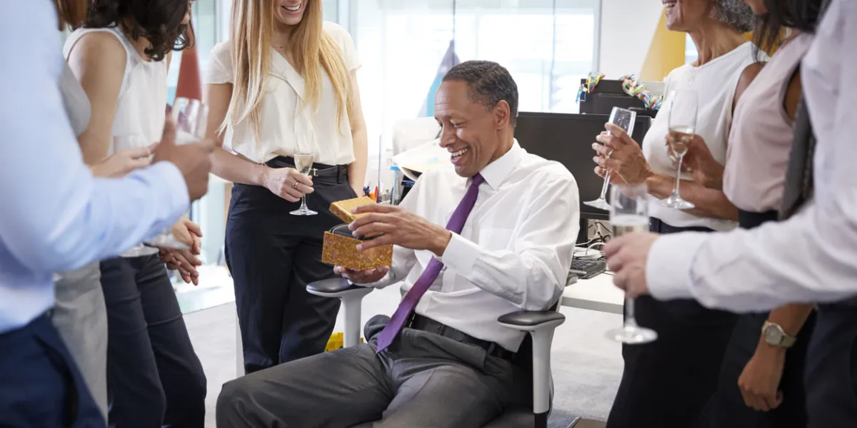 coworkers celebrating a colleague's retirement in the office