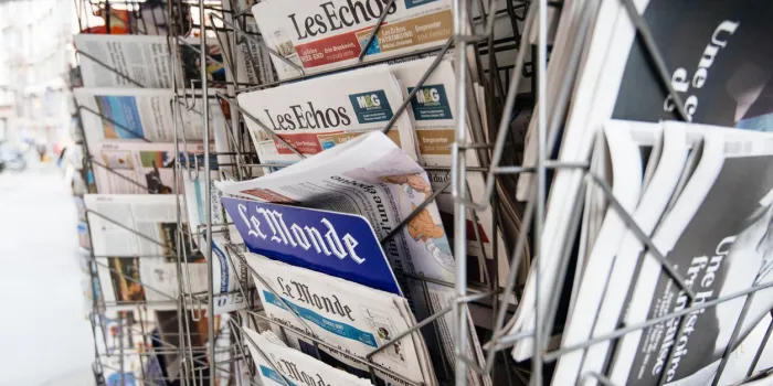 paris, france - sep 27, 2019  street view of stand with le monde, les echo and other french international newspaper titles covers at press kiosk stand