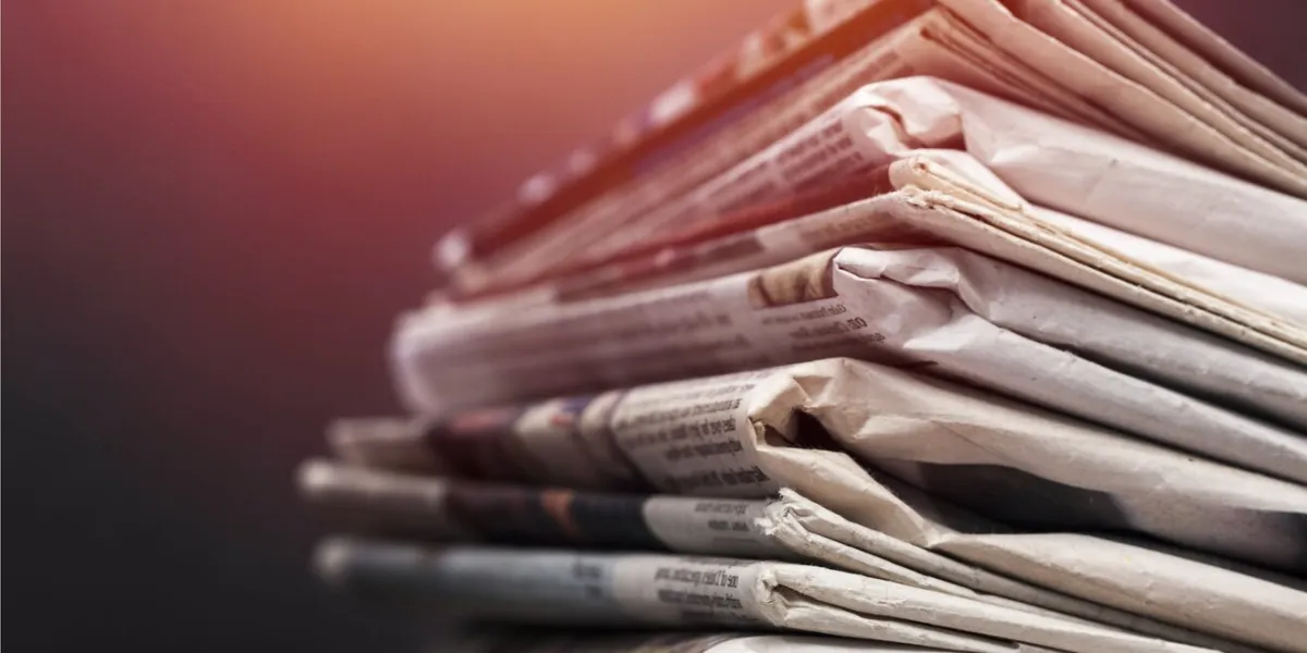 pile of newspapers on white background