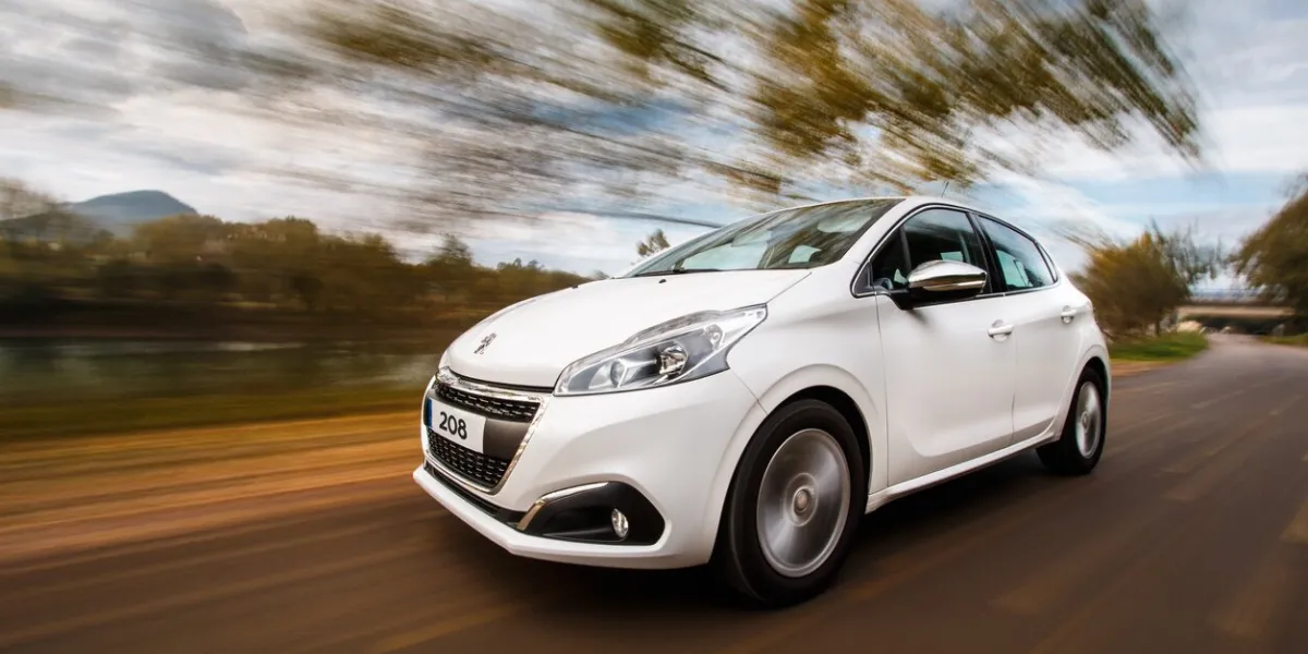 cantabria, spain - november 4,2016  white peugeot 208 being driven on a highway
