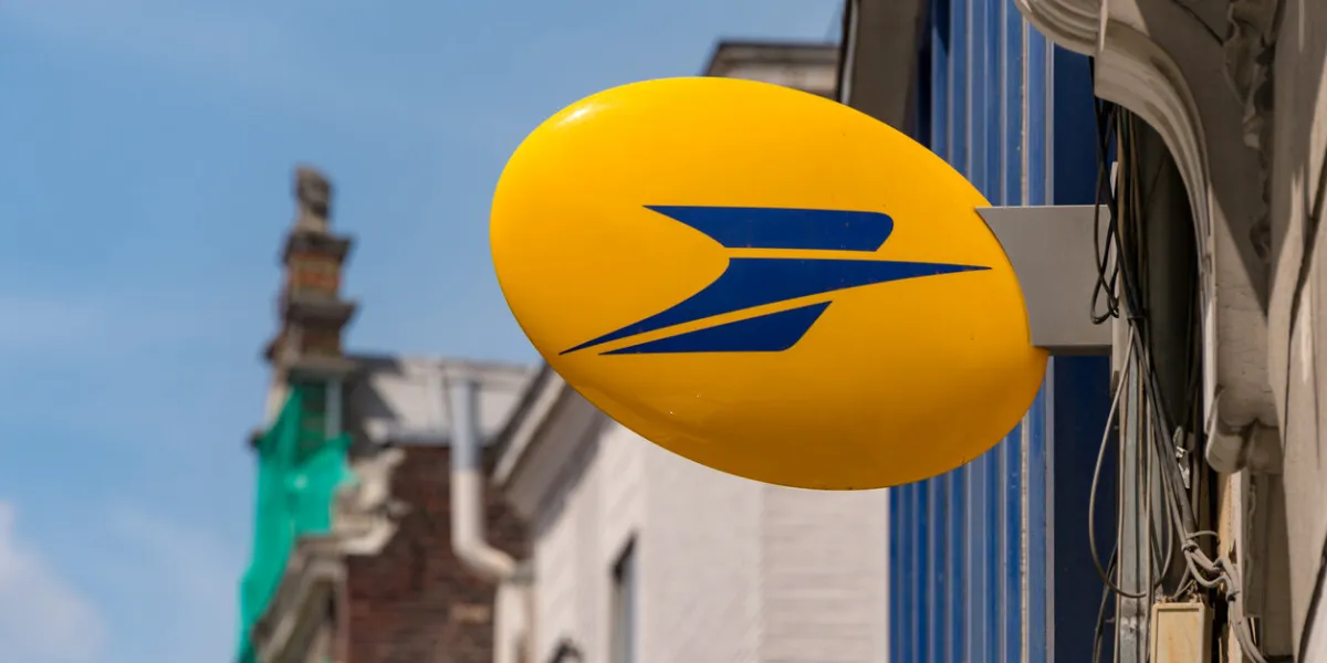 lille, france - 15 june 2018  logo of la poste, french national postal service on rue nationale