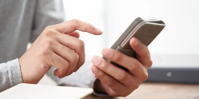 japanese man at hand using a smartphone