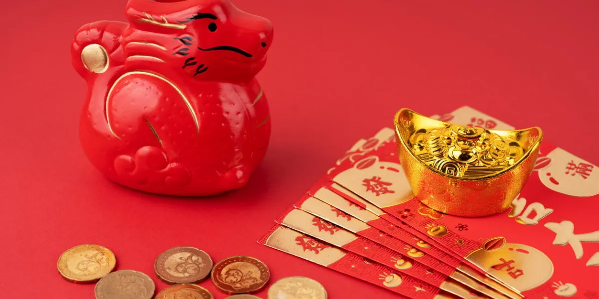 year of the dragon with red envelope and gold ingot and coins