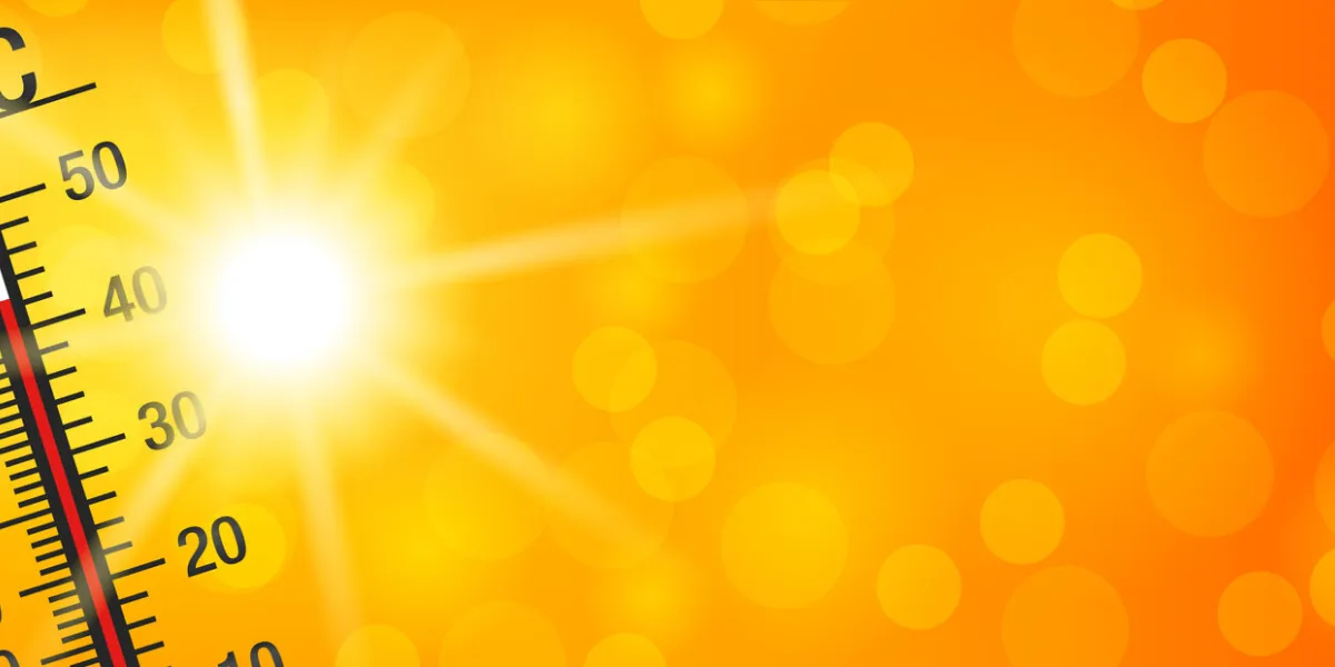 summer sun with a thermometer on a yellow and orange bokeh background