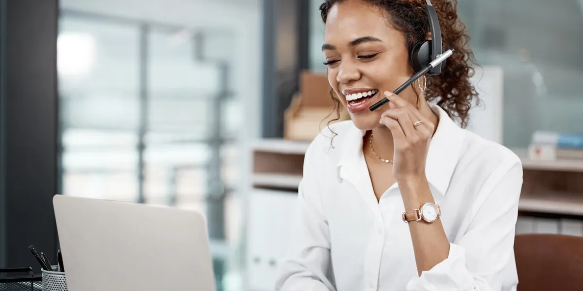cropped shot of an attractive young female call center agent working at her desk in the office