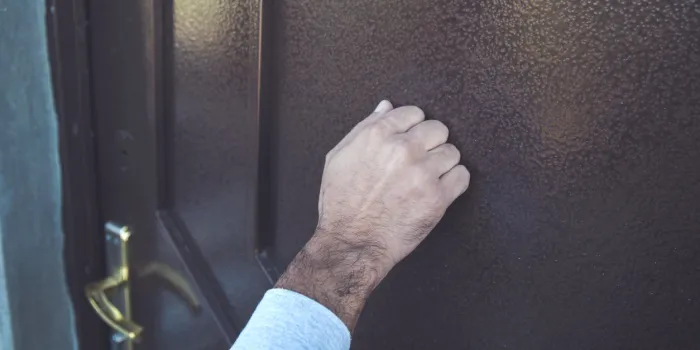 young man knock in house door