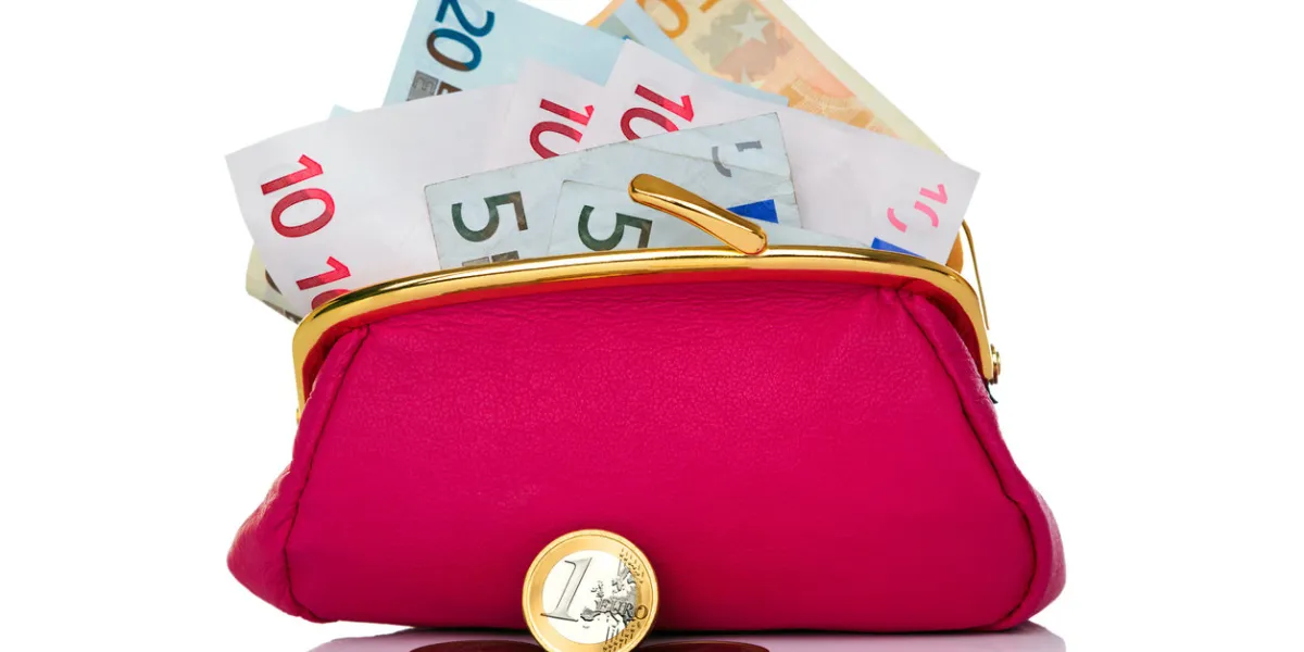 photo of a purse full of cash euro banknotes and coins in front, studio shot on a white background