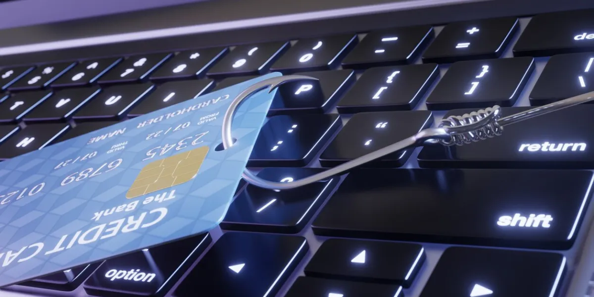 credit card on a laptop is being stolen by a fish hook illustration of the concept of email and phone phishing and internet scams