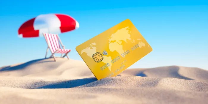 credit card at summer beach with umbrella and sun chair