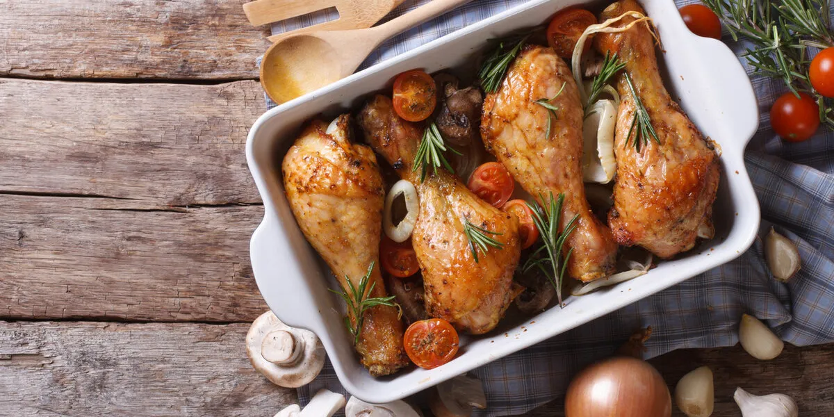 baked chicken legs with mushrooms and vegetables horizontal view from above