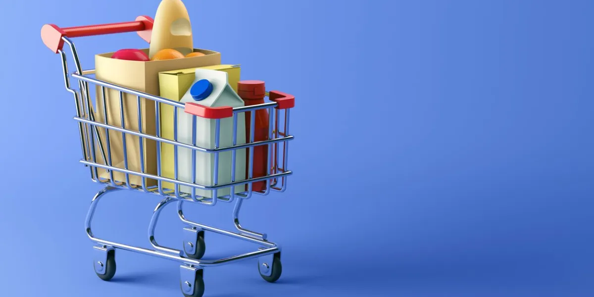 shopping cart full of food on blue background