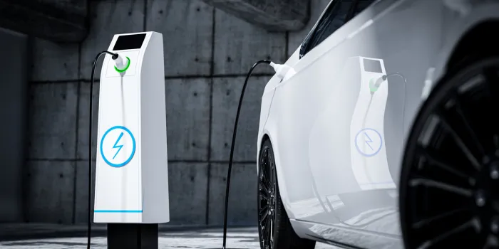 charging an electric car with a public charger in a parking lot