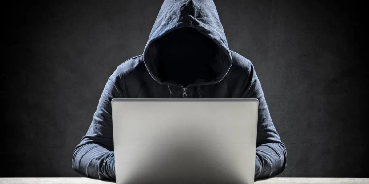 computer hacker stealing data from a laptop concept for network security, identity theft and computer crime