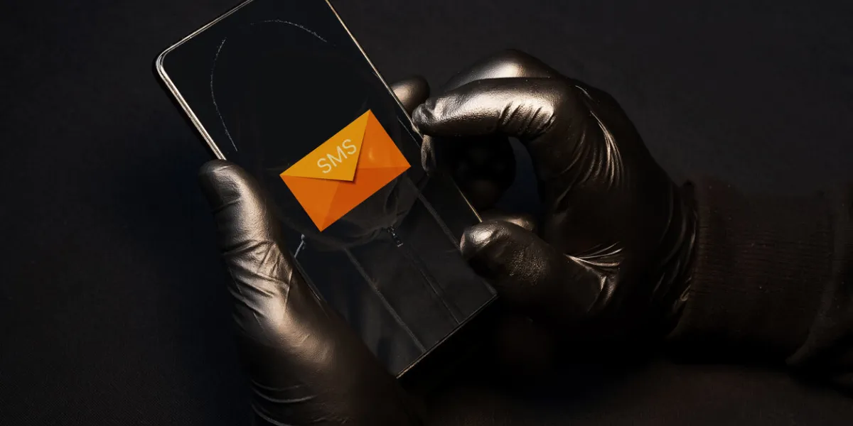 smishing alert a cybercriminal sending fraudulent text messages via cell phone to scam vulnerable people smishing danger