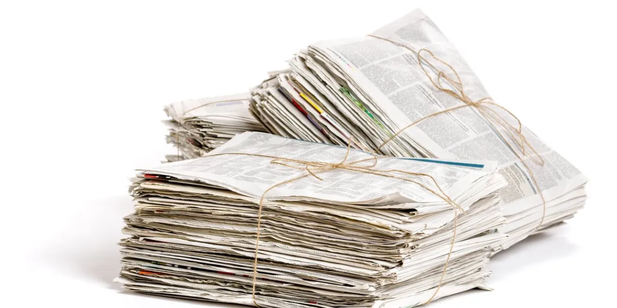 some bundles of newspapers on a white background