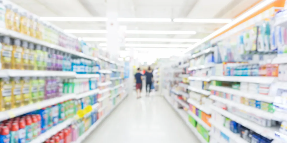 abstrack blurred bokeh supermarket with food and drink on shelf, business background