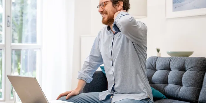 painful guy aching from pain in back or reins at home