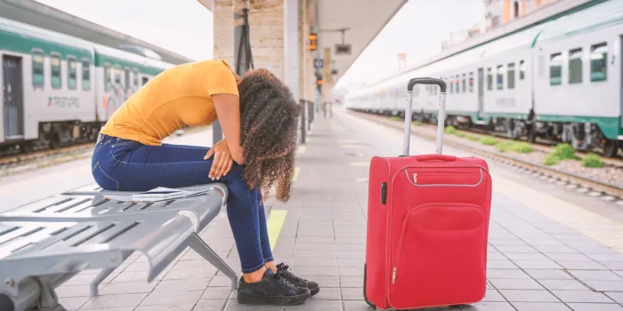 bored traveler waiting for the train in station platform