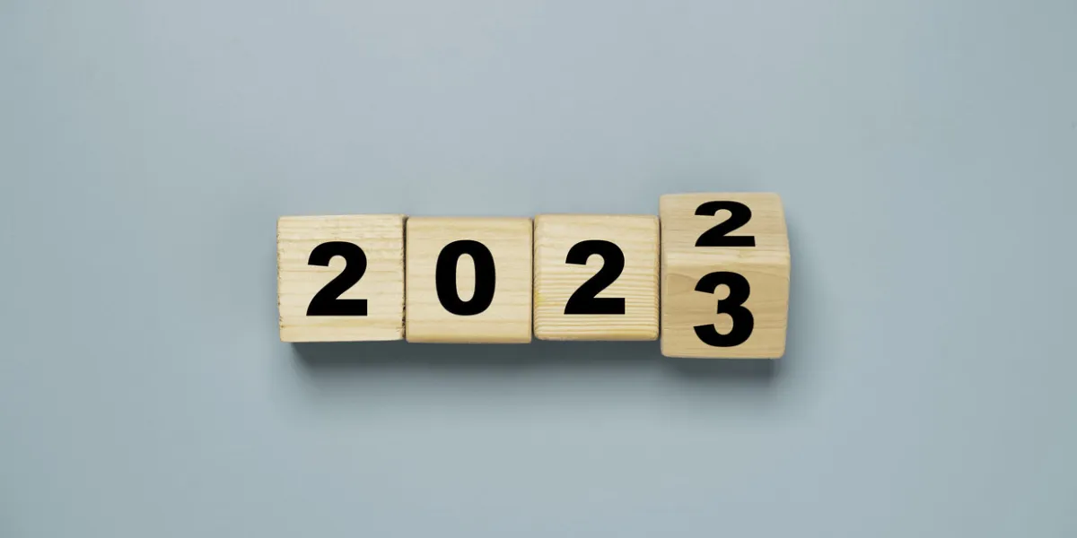 wooden block cube flipping between 2022 to 2023 for change and preparation merry christmas and happy new year