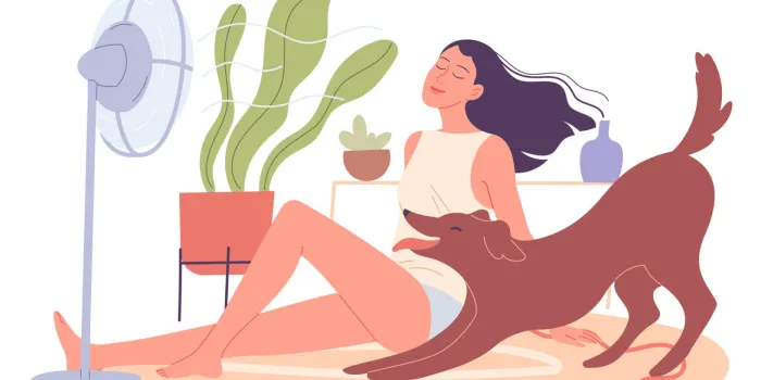 girl and her dog are chilling at home by the fan