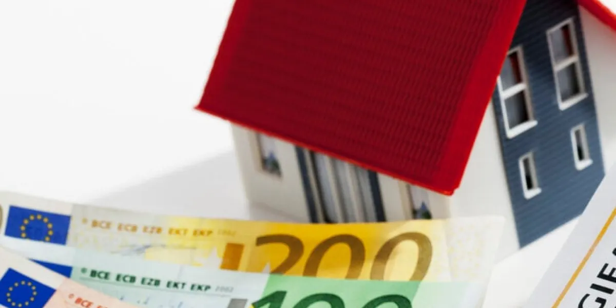 model house with energy performance certificate and bunch of euro notes