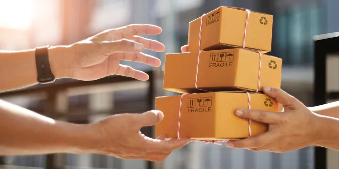 hands of customer receiving a cardboard boxes parcel from delivery man in the morning, delivery service concept