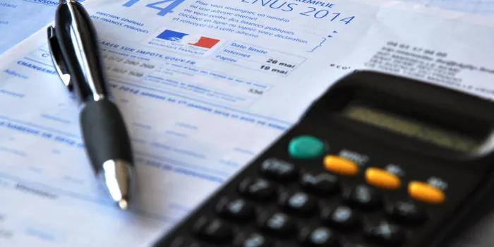 composition income tax sheet with calculator and pen