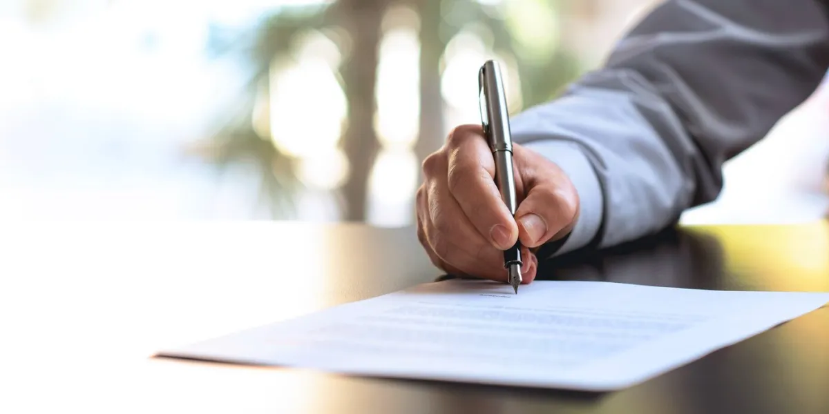 businessman signing an official document