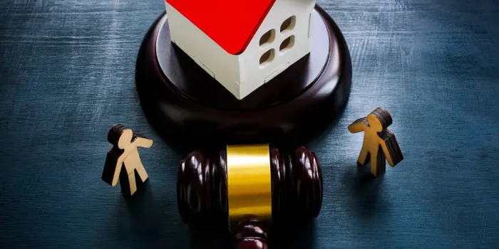 figurines, a model of a house and a gavel, as a concept of inheritance law