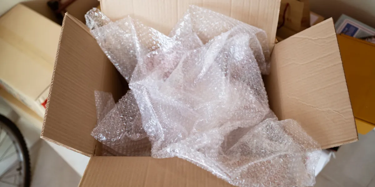 an opened cardboard box with bubble wrap inside