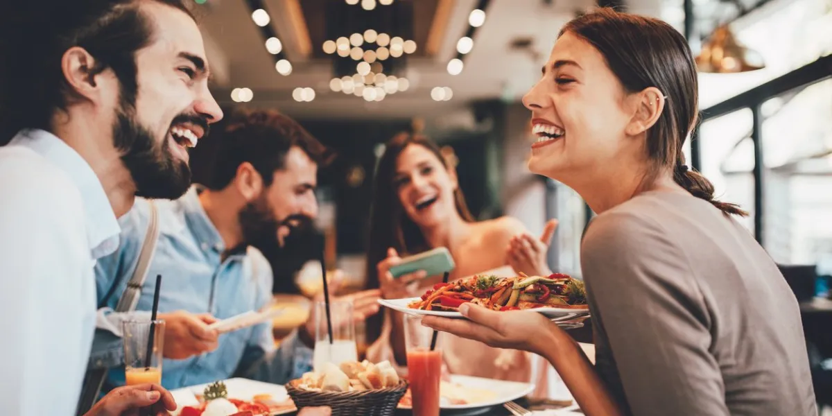 group of happy friends having breakfast in the restaurant