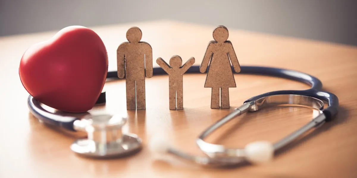 medical insurance concept with family and stethoscope on wooden desk