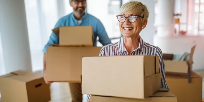 portrait of happy smiling senior couple in love moving in new home