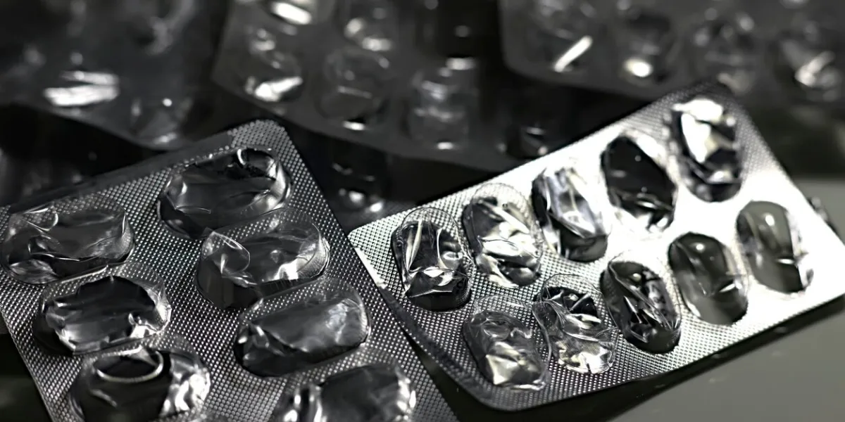 closeup of empty pill blister isolated on black background