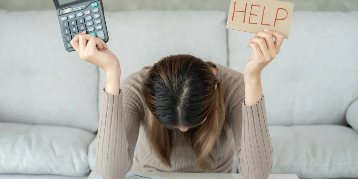 stressed and headache asian woman with large bills or invoices no money to pay to expenses and credit card debt shortage, financial problems, mortgage, loan, bankruptcy, bankrupt, poor, empty wallet