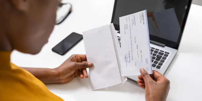 american african holding paycheck or payroll check