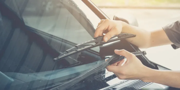 hand picking up windscreen wiper,picture vintage style