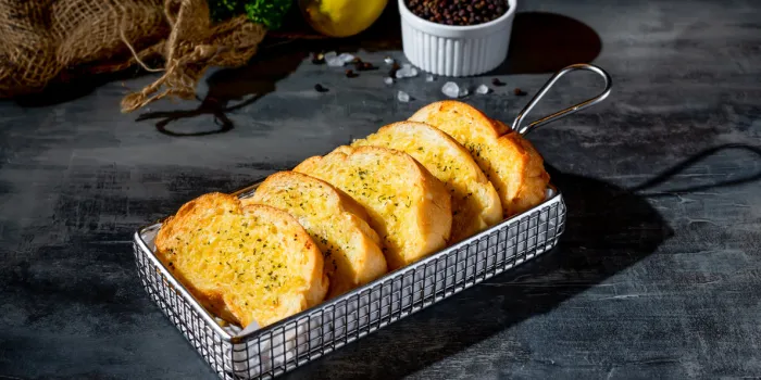 cheese garlic bread in a deep fryer dish top view on dark background a morning meal