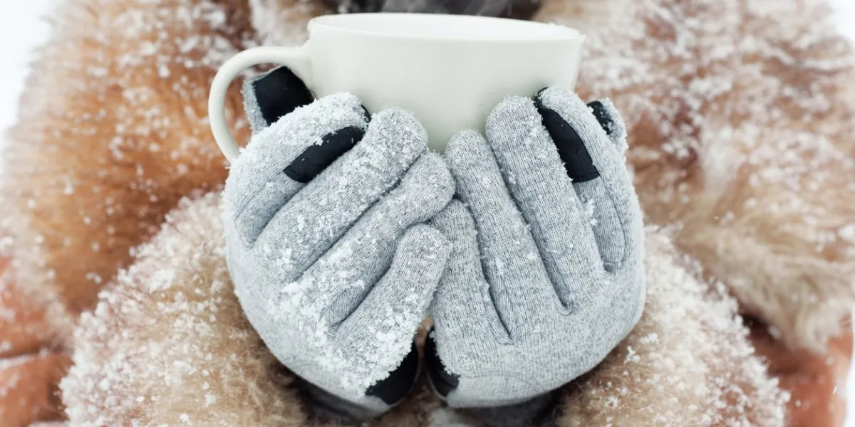 woman holding a mug to get warm in winter