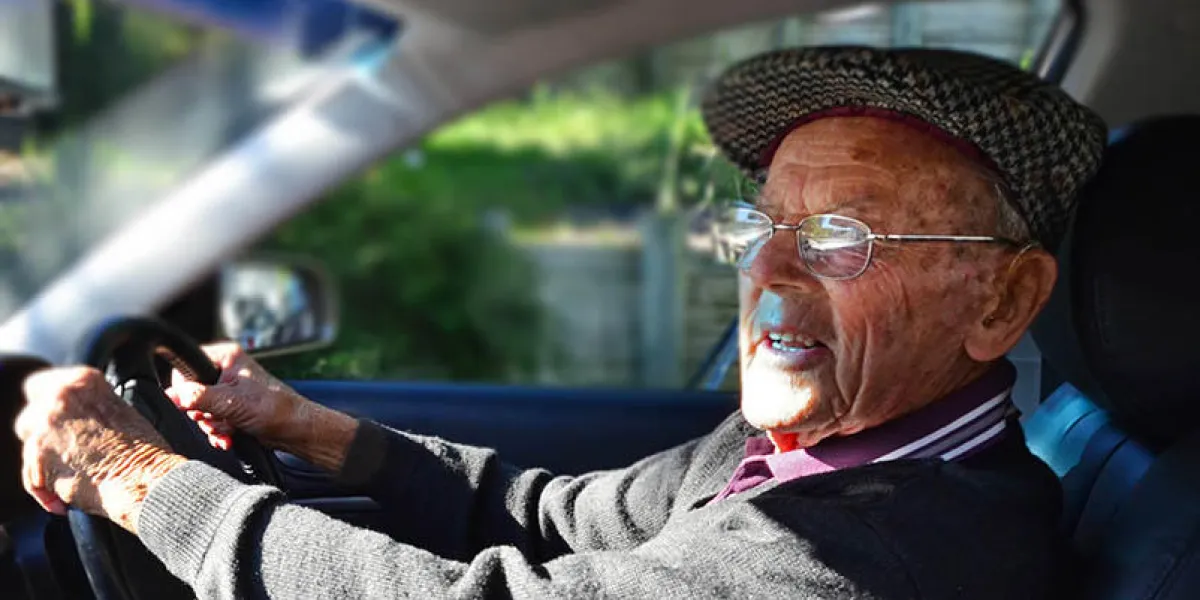 a very old man with a valid driving license drives a car