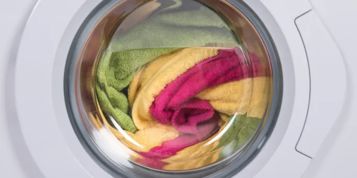 closeup of washing machine full of dirty clothes